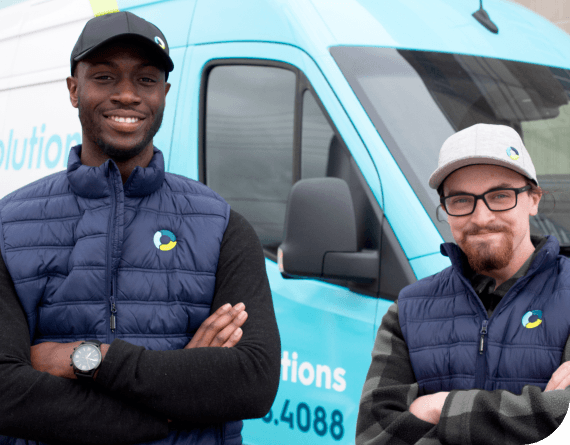 2 waste solutions employees in uniform smiling in front of van