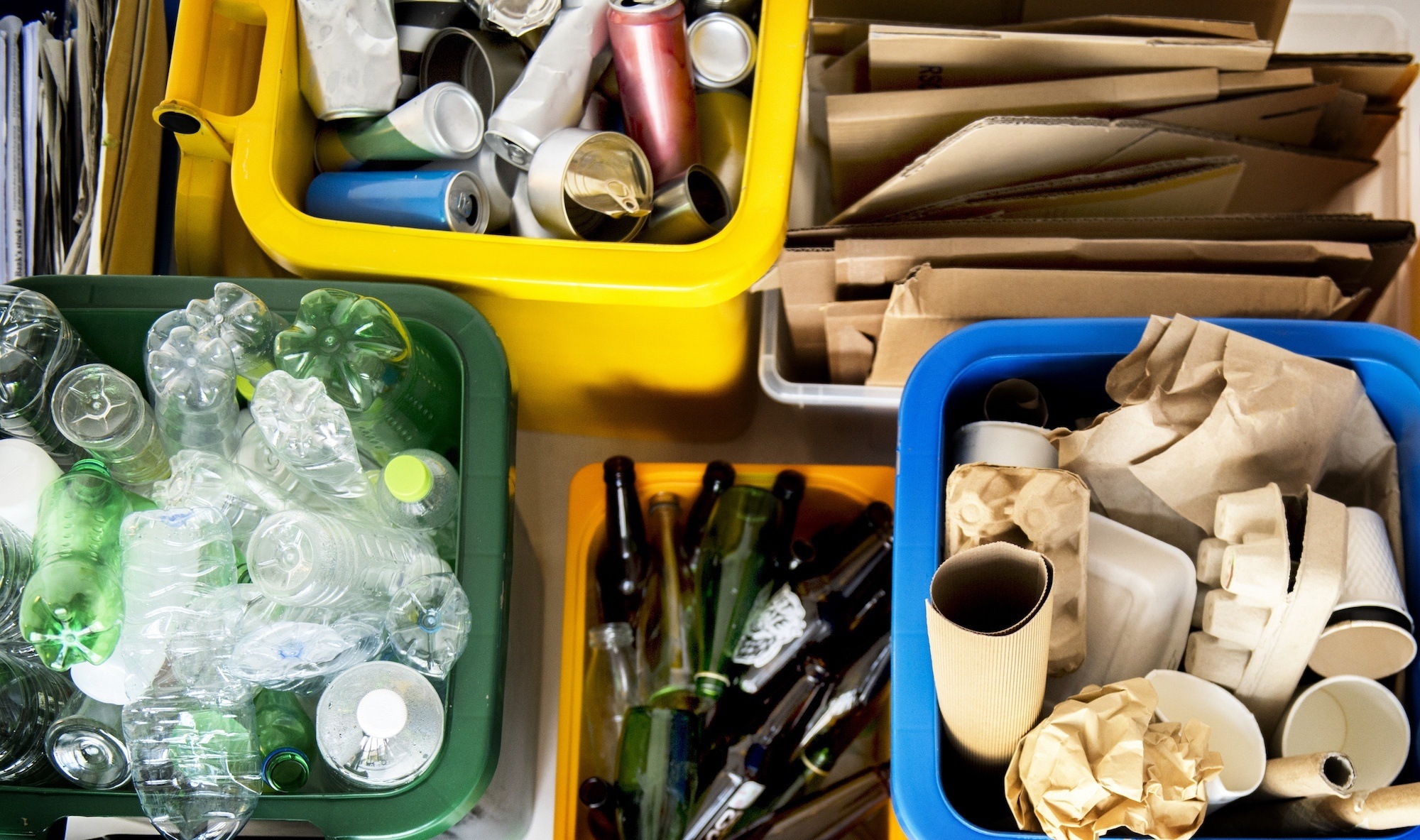 top down shot of open recycling bins with items sorted by type