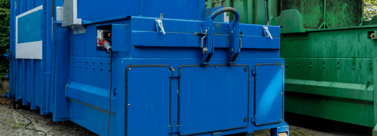 closeup of huge dumpster and waste compactor