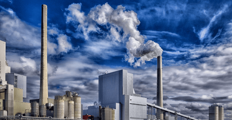 Factory emitting pollution into the air, contributing to environmental impact.