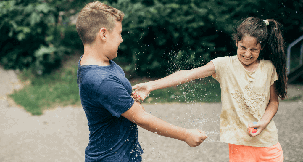 Children playing with water outdoors promoting eco-friendly waste management.