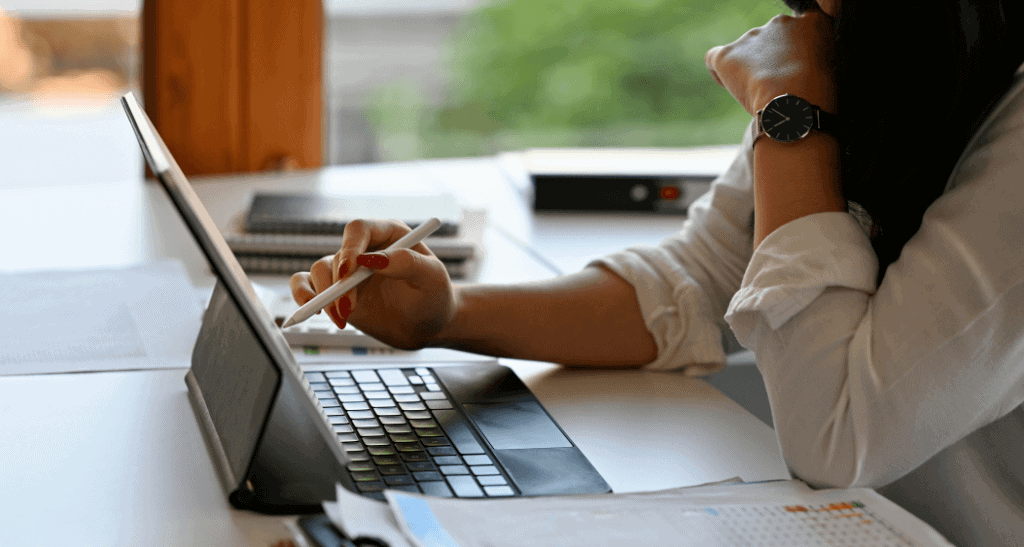 Businesswoman reviewing waste audit data on tablet for regulatory compliance.