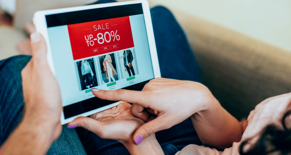 Person shopping online for clothing sale on tablet, promoting textile waste reduction in Canada.