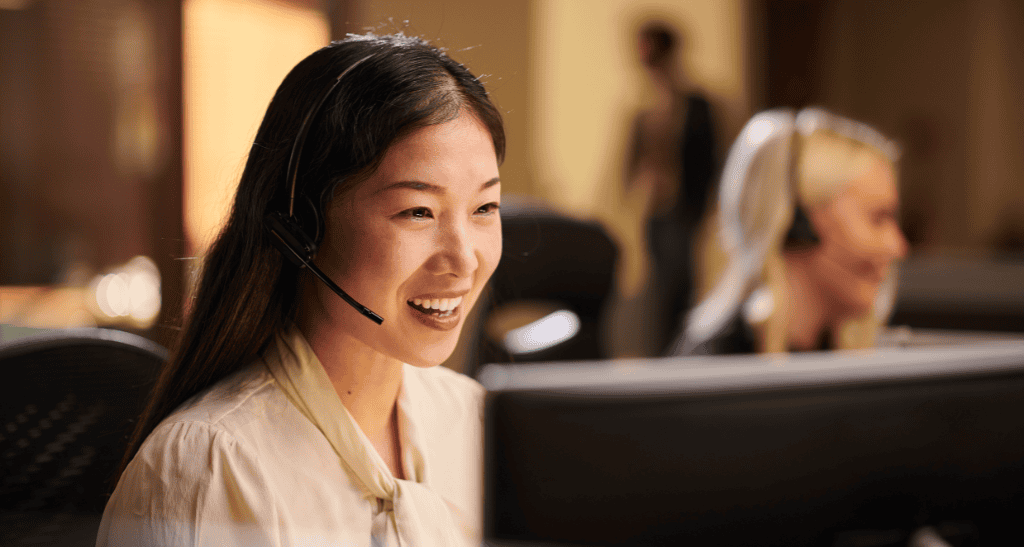 Customer support agent with headset providing eco-friendly waste solutions.
