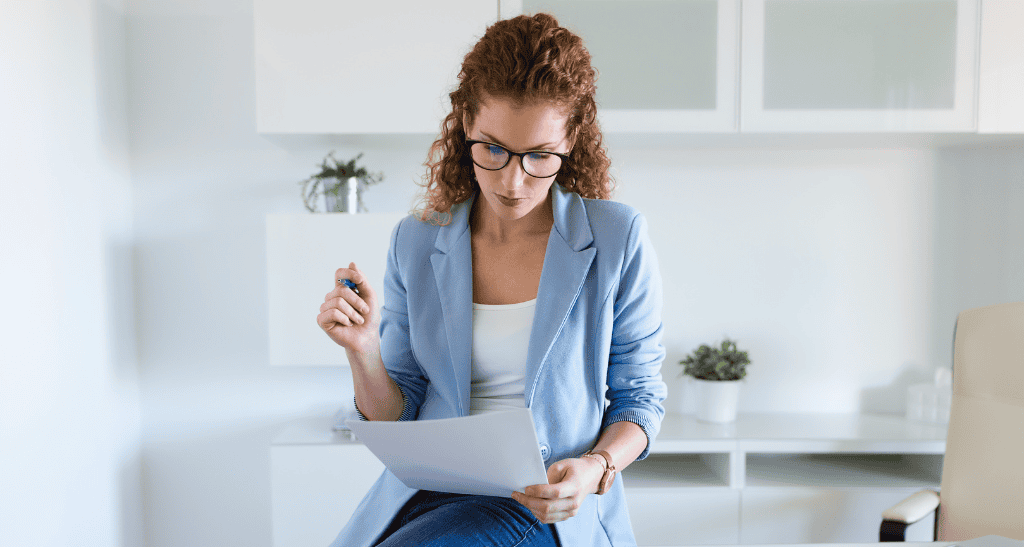 Woman reviewing waste management plan for spring cleaning and waste reduction.