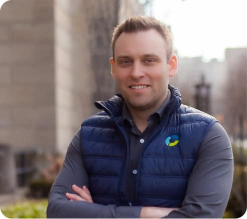 Professional waste solutions specialist outdoors, smiling confidently.