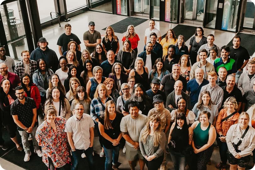 Group photo of Waste Solutions Calgary team in a modern office setting.