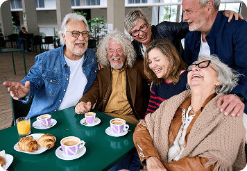 Group of seniors enjoying coffee and snacks, promoting food waste reduction.