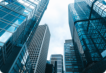 Modern urban buildings with glass facades, highlighting sustainable waste management solutions.