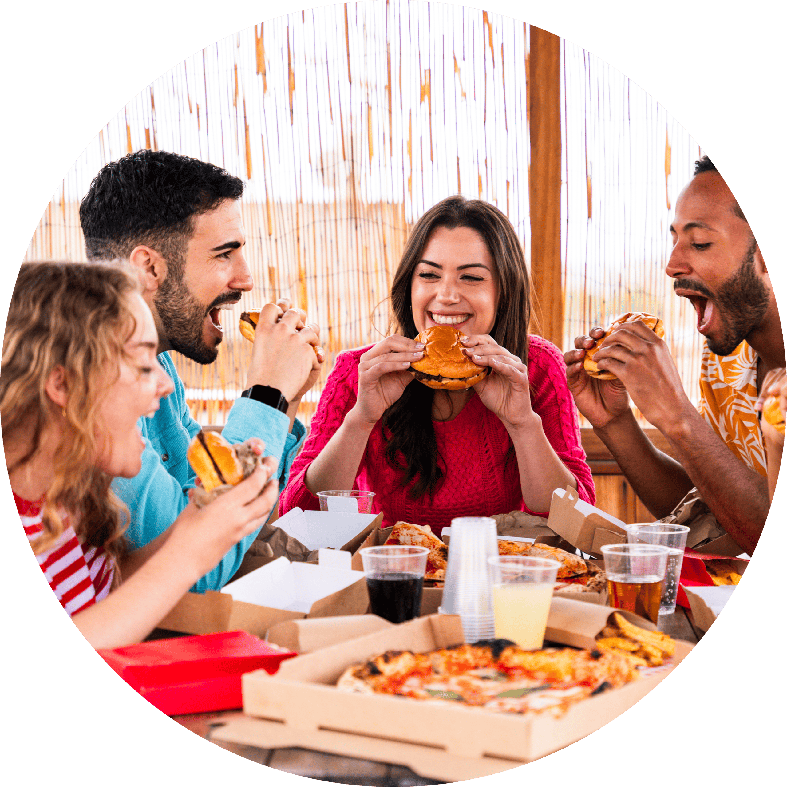 Group of friends enjoying fast food at a restaurant table.