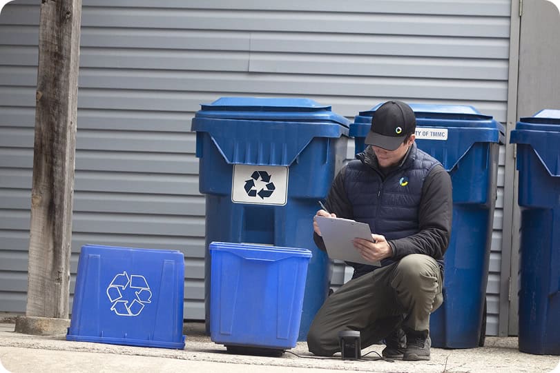 Recycling bin inspection for waste audit analysis.