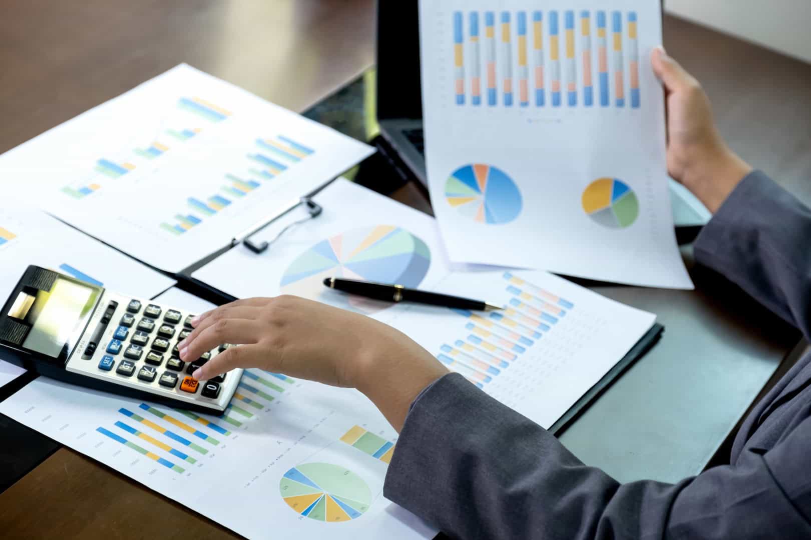Business analyzing waste data with charts and calculator for sustainable solutions.