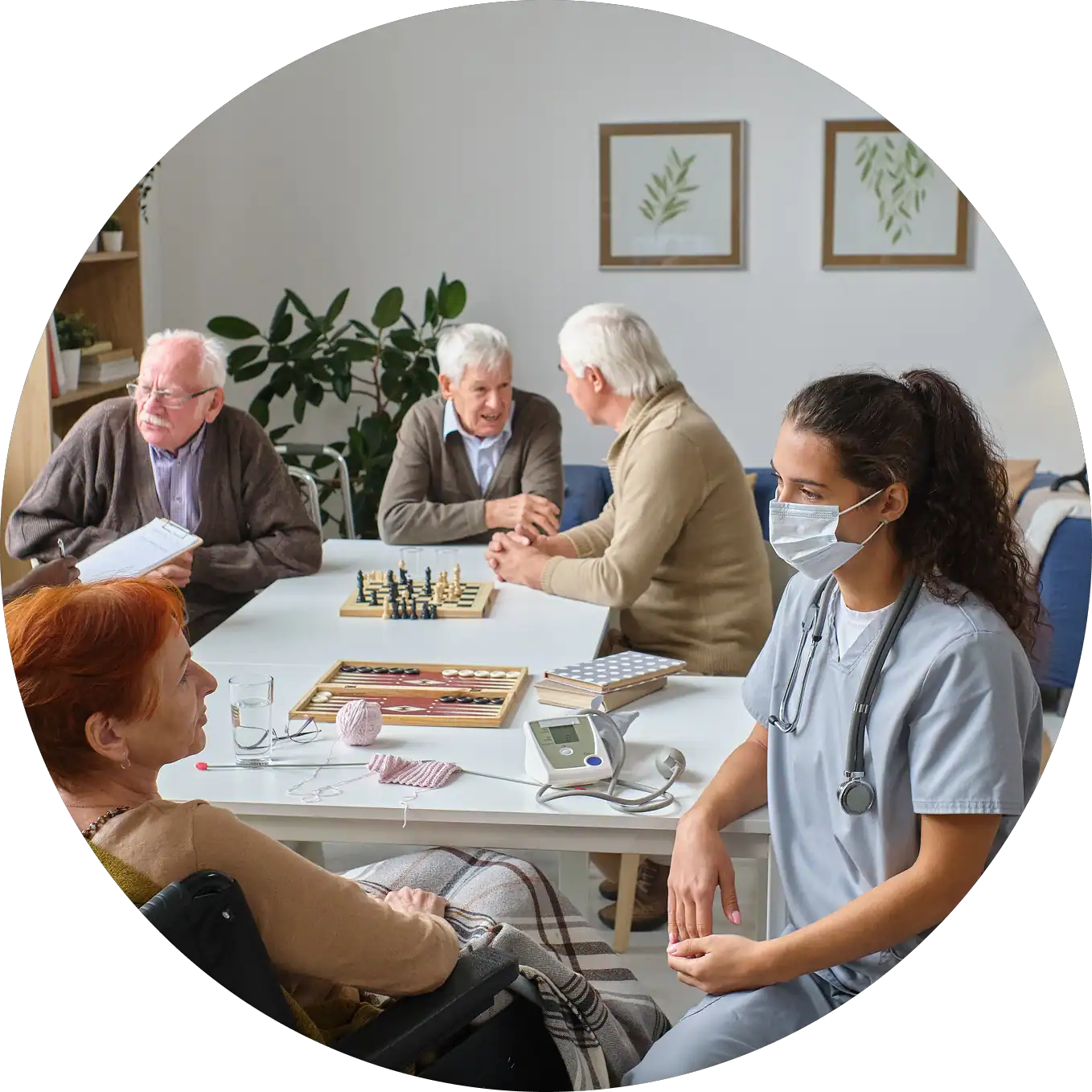 Elderly residents playing chess with healthcare staff in a care facility.