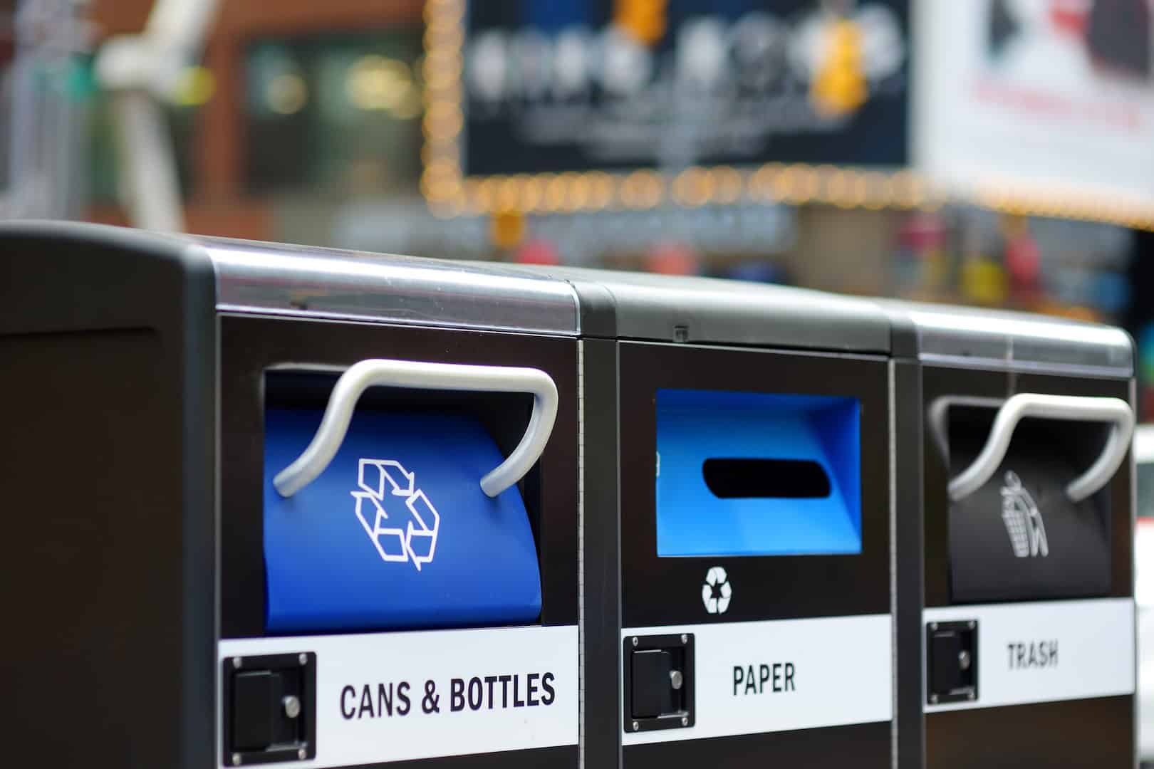 Recycling bins for cans, bottles, paper, and trash to promote eco-friendly waste management.