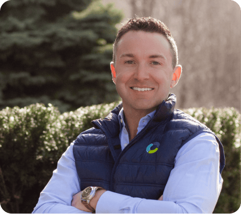 Professional waste management specialist outdoors, smiling confidently.